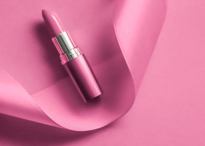 High angle view of lipstick against pink background