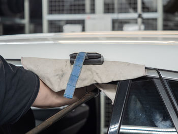 Man working on car window