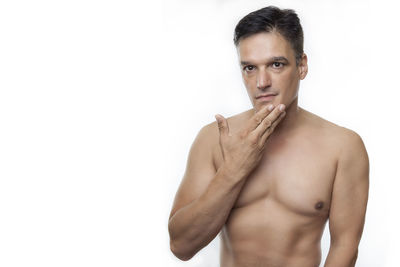 Portrait of shirtless man against white background