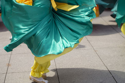 Low section of woman wearing traditional clothing dancing