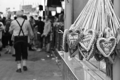 Close-up of gingerbread cookies for sale against crowd on street