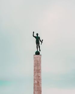 Low angle view of statue against sky