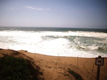 Scenic view of beach against clear sky