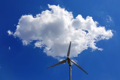 Low angle view of wind turbine against blue sky