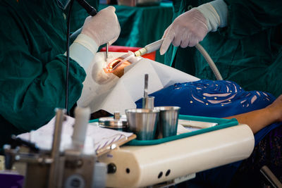 Dentists operating patient in office