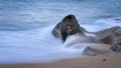 Waves splashing on rocks at shore