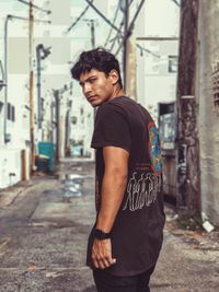 Young man standing in city