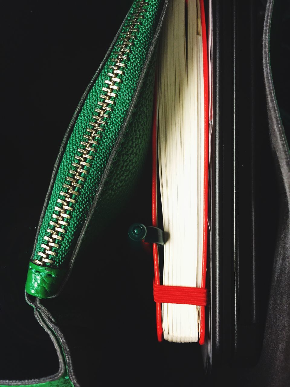 indoors, close-up, green color, black background, no people, hanging, part of, multi colored, studio shot, pattern, red, night, fabric, textile, detail, design, fashion, still life, dark, curtain