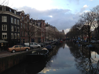 Boats in canal with buildings in background