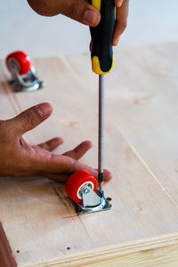 Midsection of person working on wood