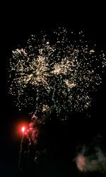 Low angle view of firework display at night