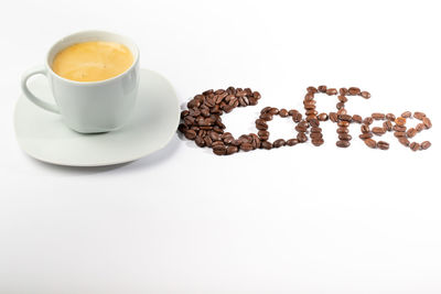 Coffee cup and cookies against white background