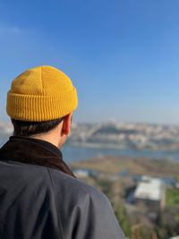 Side view of man standing against clear sky