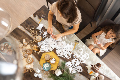 High angle view of women sitting on table