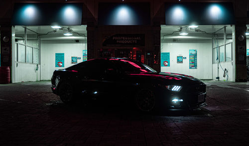 Car parked in parking lot at night