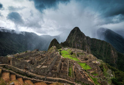 Panoramic view of mountain range against cloudy sky