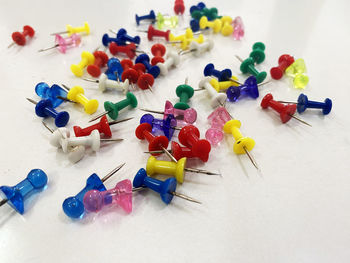 High angle view of multi colored confetti on white background