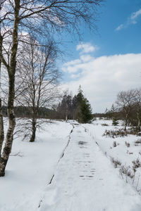 Scenic view of snow covered landscape against sky