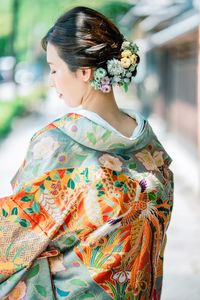 Close-up of woman in kimono wearing flowers in hair