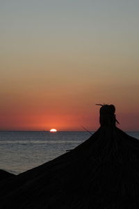 Scenic view of sea against clear sky during sunset