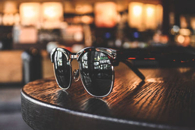 Close-up of sunglasses on wooden table