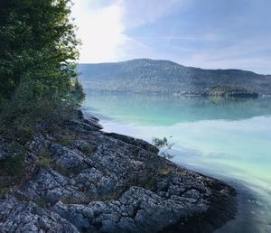 Scenic view of lake and mountains against sky