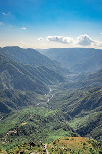 Misty mountain range covered with white mist and amazing blue sky