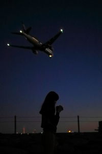 Low angle view of illuminated people at night