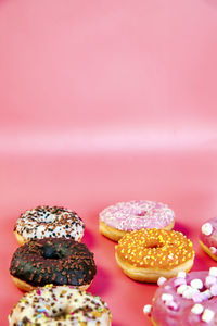 High angle view of donuts against pink background