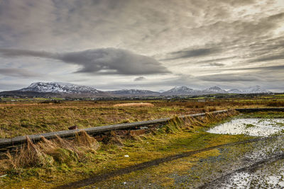 Scenic view of mountains against cloudy sky