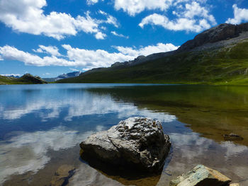 Scenic view of lake and mountains against sky