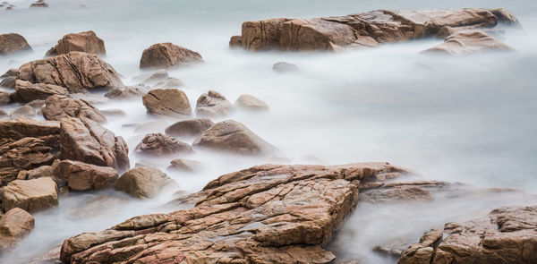 Scenic view of waterfall against rocks