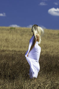 Side view of woman standing on field