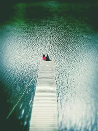 Man on jetty against sea