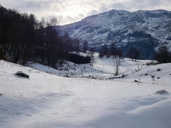 Scenic view of snow covered mountains against sky