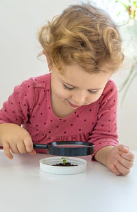 High angle view of girl drawing on book