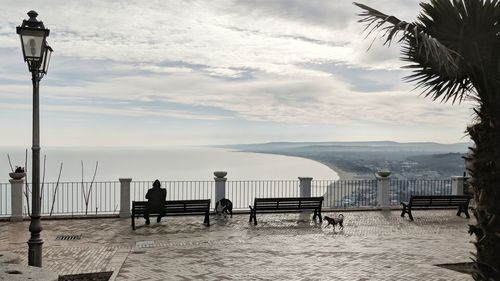 Street light by sea against sky