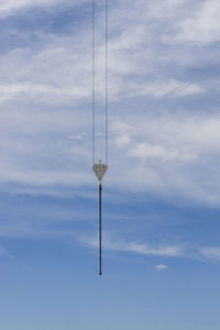 Low angle view of telephone pole against sky