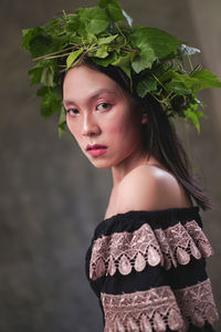 Portrait of woman standing against plants