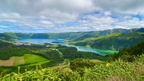 Scenic view of green landscape against sky