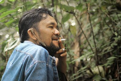 Portrait of man smoking cigarette