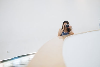 Portrait of woman photographing