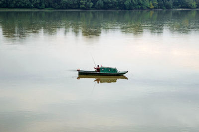 Boat moored in lake against sky