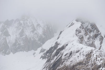 Scenic view of snow covered mountains against sky