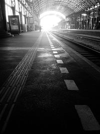 Train at railroad station in city against sky