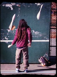 Full length of woman standing by railing