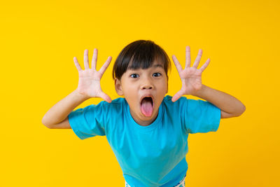 Portrait of boy against yellow background