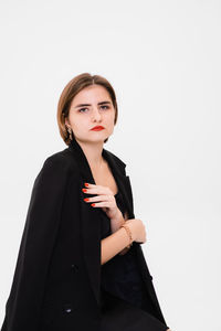 Portrait of businesswoman standing against white background