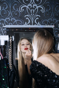 New years eve makeup ideas. beautiful young woman bright evening make-up red lips getting ready for