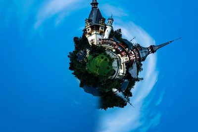 Digital composite image of traditional building against blue sky